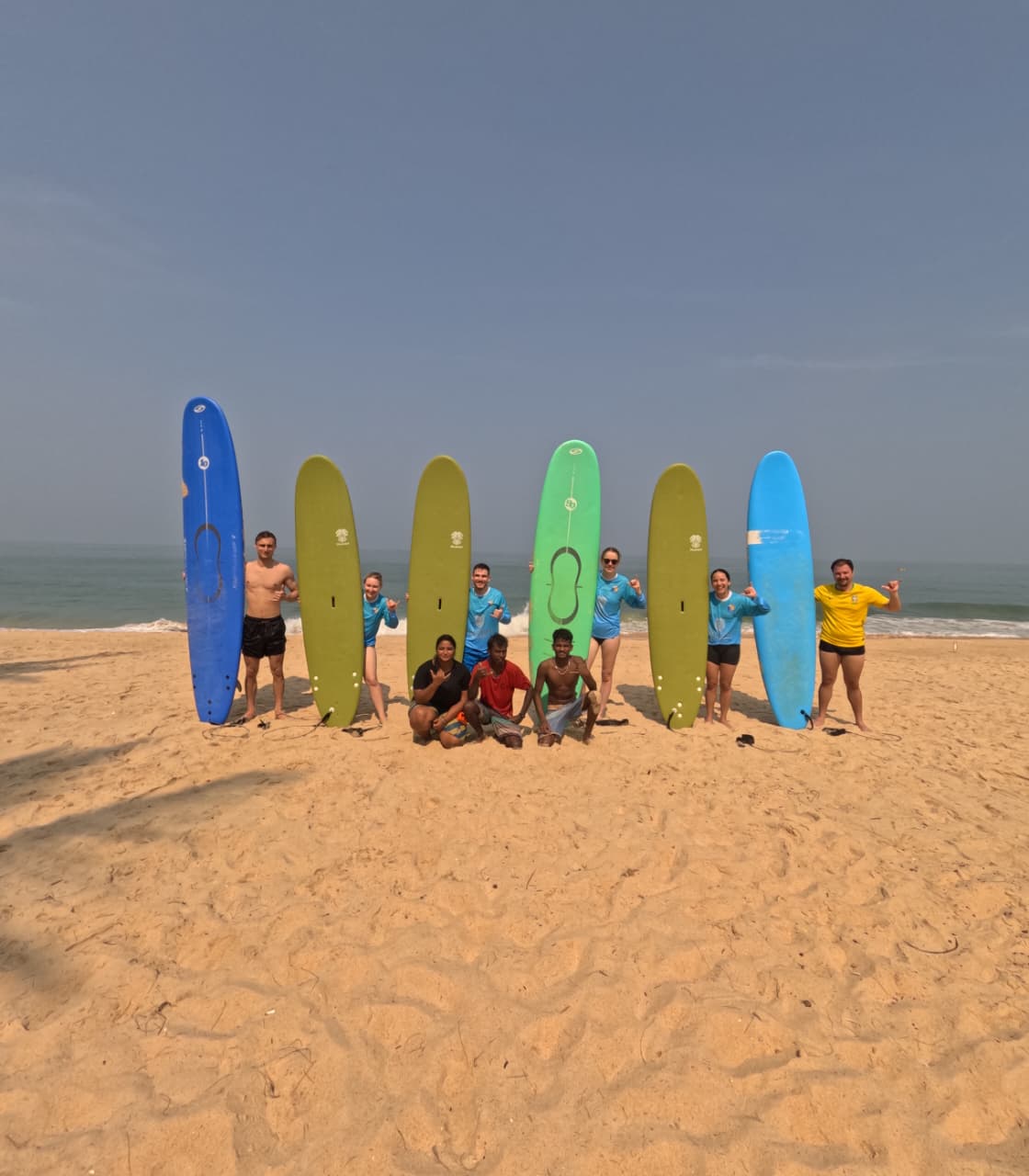 Professional surf instructor teaching beginner student proper surfing technique on Kapu Beach